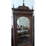 A late 19th century French Moroccan pitch pine bedroom suite comprising a wardrobe enclosed by a