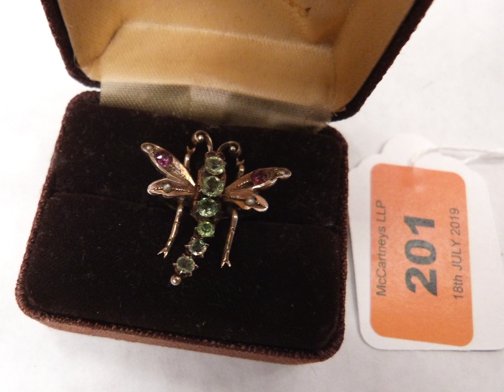 An Edwardian gold dragonfly brooch, the thorax set with six graduated green stones, the wings and