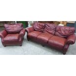 A sofa and armchair upholstered in burgundy leather