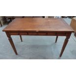 A side table with three frieze drawers on square tapered legs. 49' wide