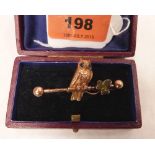 A Victorian owl on a branch bar brooch, the bird with blue gem set eyes, the leaf set with a