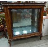 A 19th century French walnut display cabinet enclosed by a pair of sliding glass doors, on