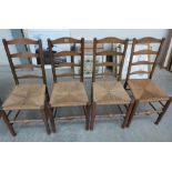 A set of four oak ladderback chairs with rush seats