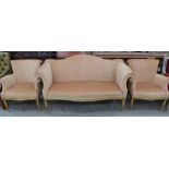 A French canape upholstered in gold fabric on gilded paterae moulded supports. Early 20th century.