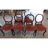 A set of four Victorian rosewood balloon back salon chairs (2 A.F.) and a pair of similar chairs