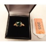 An emerald and diamond ring. In gold marked 375. Size N. 2.4g gross