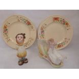 A pair of Clarice Cliff plates, a bisque group and an Austrian figure of a child