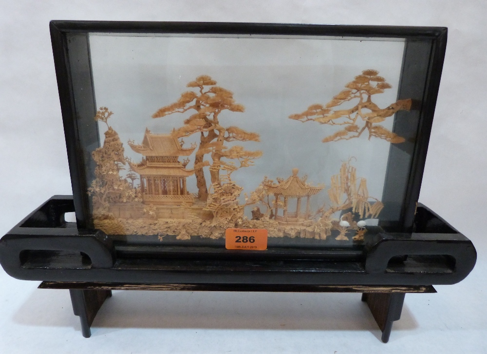 A Chinese cut cork diorama landscape, the case raised on a stand. 11½' high