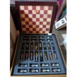 A boxed chess set with resinous pieces