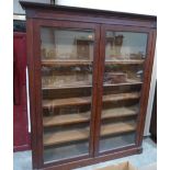 A 19th century mahogany bookcase with stepped cornice, enclosed by a pair of glazed doors. 65'