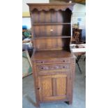 A small oak dresser with raised rack over two drawers and fielded cupboard door. 27' wide