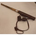 A brass and leather tubed three draw telescope, 'The Marksman' J.H. Stewart Ltd, London. 31½' long