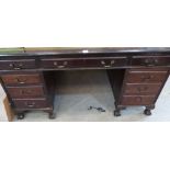 A mahogany partner's desk with leather inlet top