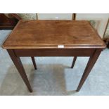 A mahogany side table on square tapered legs. 30' wide