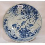 A Chinese blue and white dish painted with foliage and birds. 12' diam. Rim chips