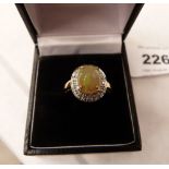 A cabochon opal and diamond ring. In gold marked 375. 2.7g gross. Size N