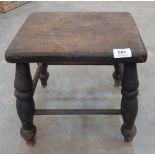 A 19th century oak stool on splayed turned legs (worm)