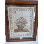 A 19th century silk embroidered and ribbonwork panel, depicting a basket of roses, other flowers and