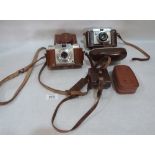 A Dacora Dignette 35mm camera; An Ansco Memar Pronto 35mm camera; a flash gun and a light meter. c.
