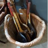 A wicker basket with cricket bat and tennis racquets