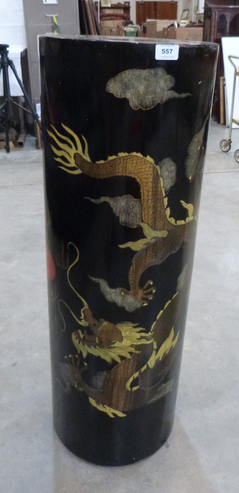 A Japanese black lacquer pedestal painted with two dragons and a flaming pearl. 36' high