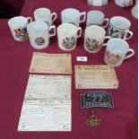 A collection of WW1 postcards, nine commemorative mugs, a Special Constable belt buckle and a badge