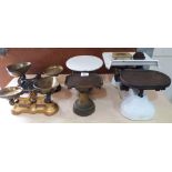 Four sets of weighing scales, with a quantity of iron and brass weights