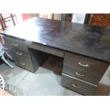 An industrial style steel pedestal desk 60' wide