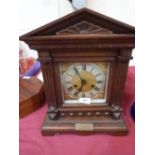 An early 20th century oak mantle clock in architectural case. 16' high