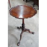 A mahogany tripod occasional table with piecrust top and egg and claw feet. 14½' diam