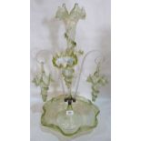 A Victorian vaseline glass epergne, hung with two glass baskets on scrolled clear glass cane