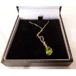 A peridot and diamond pendant. In gold marked 375. 1.8g gross