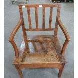 A George III fruitwood commode elbow chair.