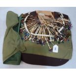 A lacemaker's work cushion with a collection of 96 treen and ivory bobbins and part completed