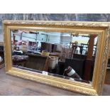 A gilt framed wall mirror with bevelled plate. 28½' x 16½'