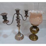 A brass oil lamp and a plated three light candelabrum