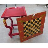 An oriental style red lacquer occasional table and a red lacquer chess board