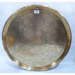 An Islamic brass foliate chased tray top. 21¾' diam