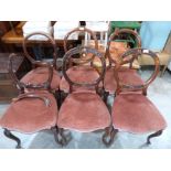 A set of four Victorian rosewood balloon back salon chairs (2 A.F.) and a pair of similar chairs