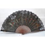 A fan by Ronot-Tutin, the lace work leaf finely painted with berry fruits. c.1890. Signed 25'