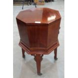 A George III style mahogany cellarette of octagonal form on splayed square legs with carved