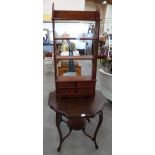 A mahogany two tier centre table and hanging wall shelves