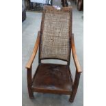 An early 20th century beechwood elbow chair with twisted rush back