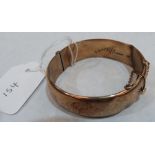 A foliate engraved hinged bangle. In gold marked 375. 21.7g
