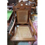 A Victorian oak elbow chair with caned back and seat