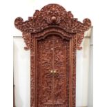 A fine and magnificent Balinese doorway, profusely carved all over with figures, foliage,