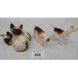 A Beswick Siamese kitten group and a pair of fox hounds