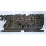 An Indian hardwood plaque, carved and pierced with elephant, stylised figures and dragon. 24' wide