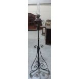 A wrought iron telescopic oil lamp standard with Hinks Duplex burner