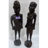 A pair of carved wood male and female figures. 18' high